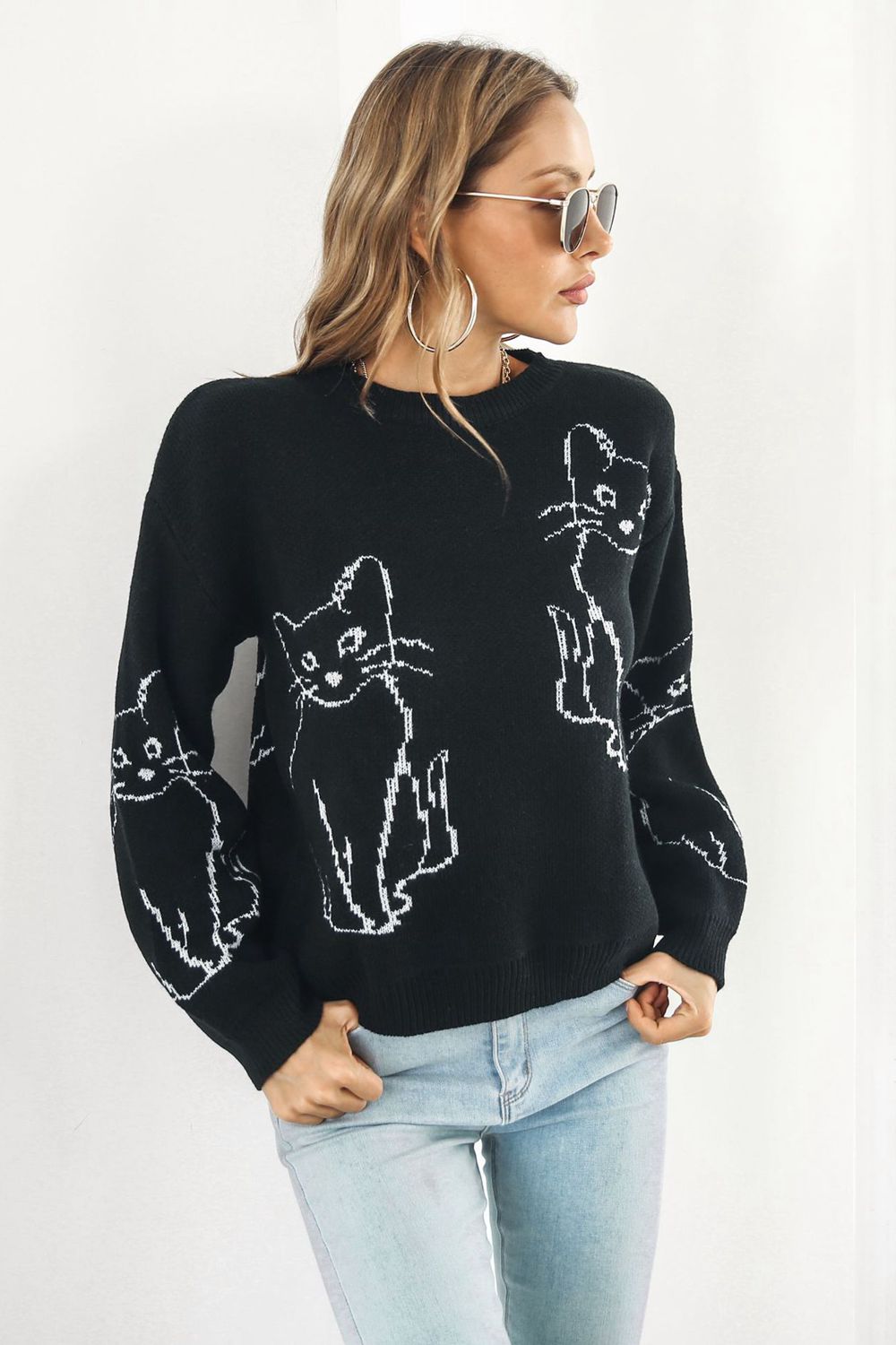 Black acrylic sweater with white cat intarsia knit pattern, crew neck, long sleeves.