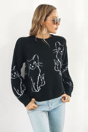 Black acrylic sweater with white cat intarsia knit pattern, crew neck, long sleeves.