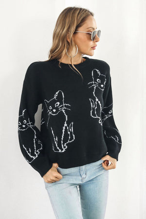 Black acrylic sweater with white cat intarsia knit pattern, crew neck, long sleeves.