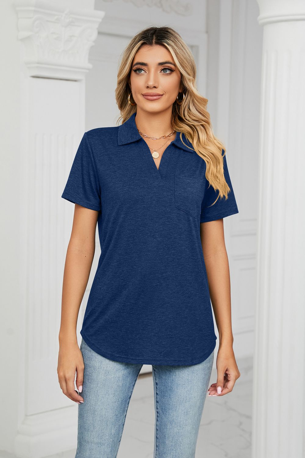Navy V-neck polo shirt with short sleeves and a chest pocket.