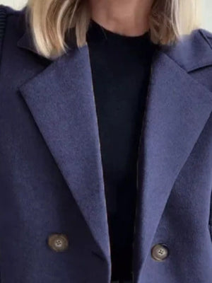 Navy double-breasted wool blend blazer with two buttons and notched lapels.