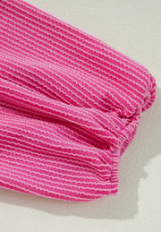 Hot pink blouse with textured horizontal stripes and gathered sleeve detail
