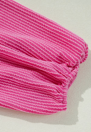 Hot pink blouse with textured horizontal stripes and gathered sleeve detail