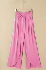 Pink wrap-front palazzo pants with tie waist and slit hem