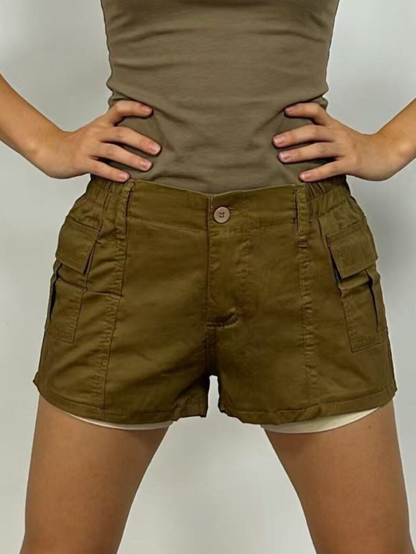 Khaki cargo shorts with button fly, elastic waist, and multiple pockets.