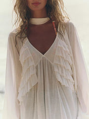 White sheer ruffle trim beach cover-up with deep V-neck and long sleeves.