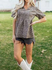 Leopard print V-neck denim top with short sleeves and a tiered bodice.
