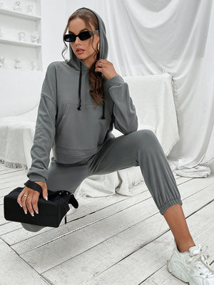 Dark gray cropped hoodie and joggers set with drawstring hood and elastic cuffs.