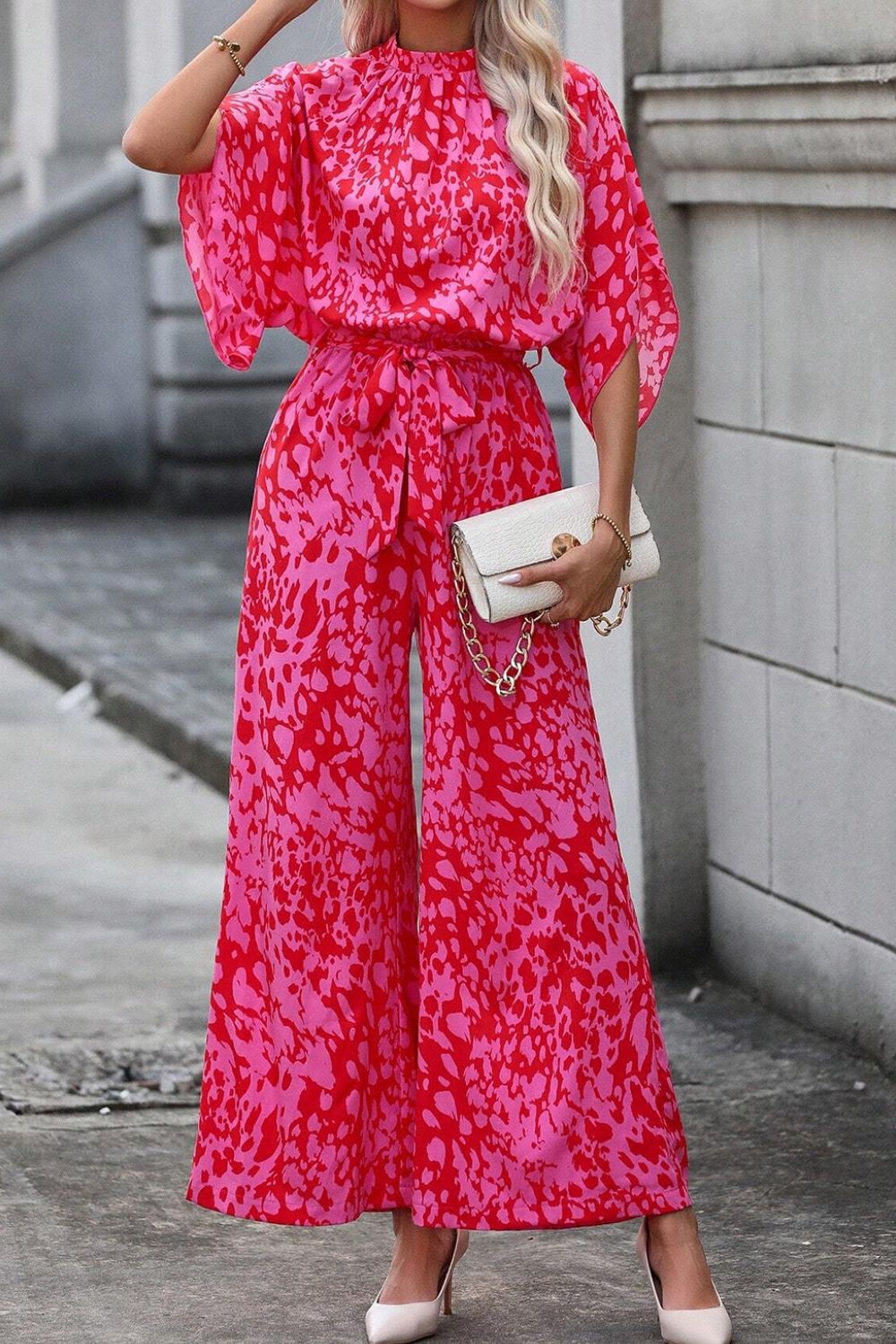 Crimson Splatter Tie-Waist Palazzo Jumpsuit in hot pink with wide legs and dolman sleeves.