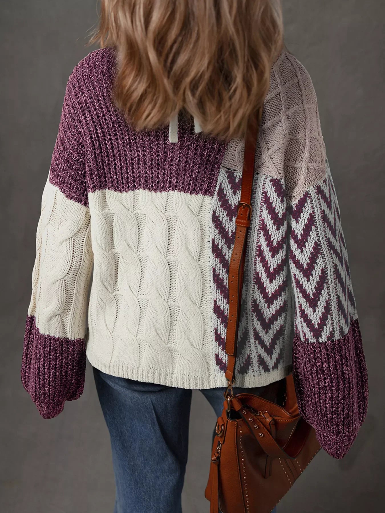 Patchwork cable knit sweater in mauve with cream and light pink panels and chevron pattern.