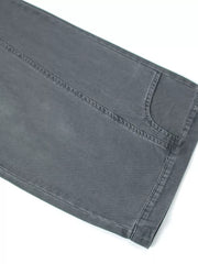 Grey cotton sweatpants with wide legs and visible stitching detail.