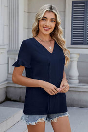 Dark navy textured V-neck blouse with ruffle sleeve detail and pintuck front.
