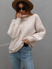 Voluminous turtleneck ribbed knit sweater in beige, featuring balloon sleeves and a relaxed fit.