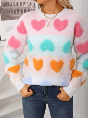 Fuzzy knit sweater with colorful heart pattern, crew neck, long sleeves, and cozy acrylic blend.