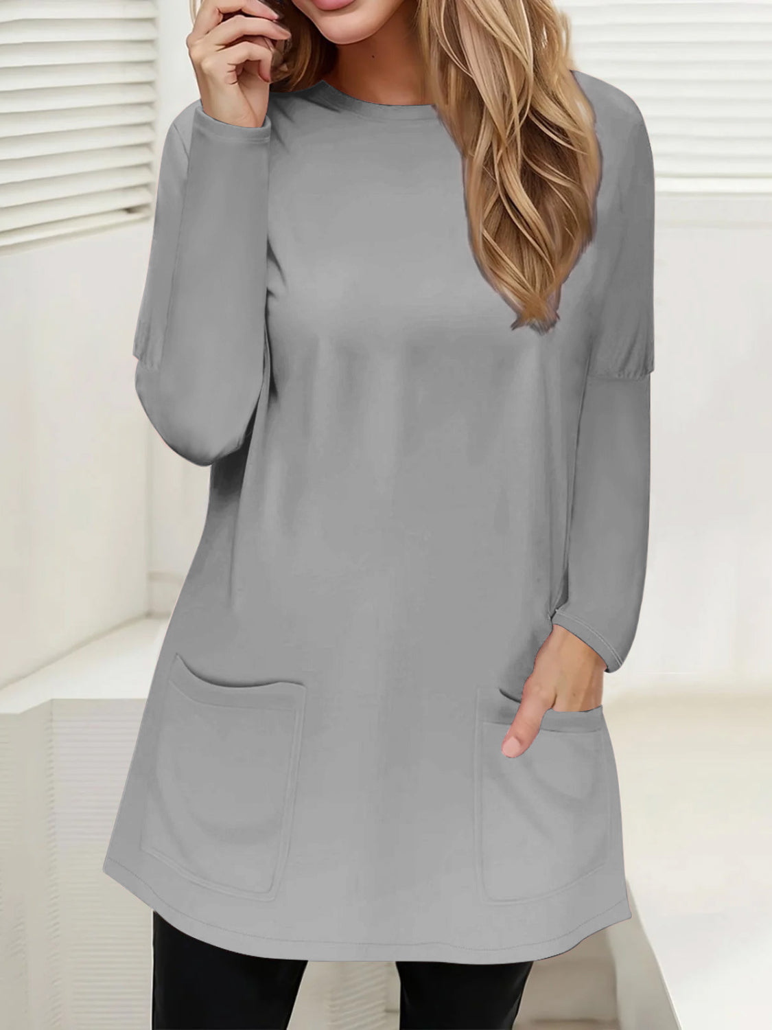 Gray relaxed fit tunic with long sleeves and two patch pockets.