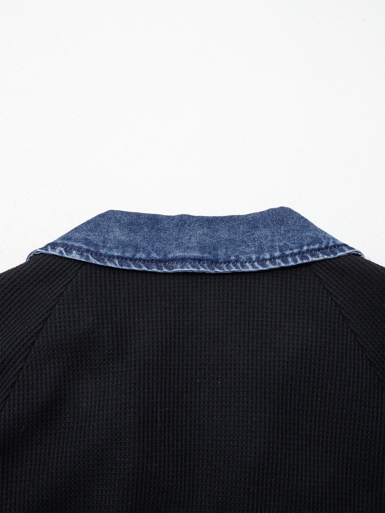 Black textured knit polo top with denim collar detail