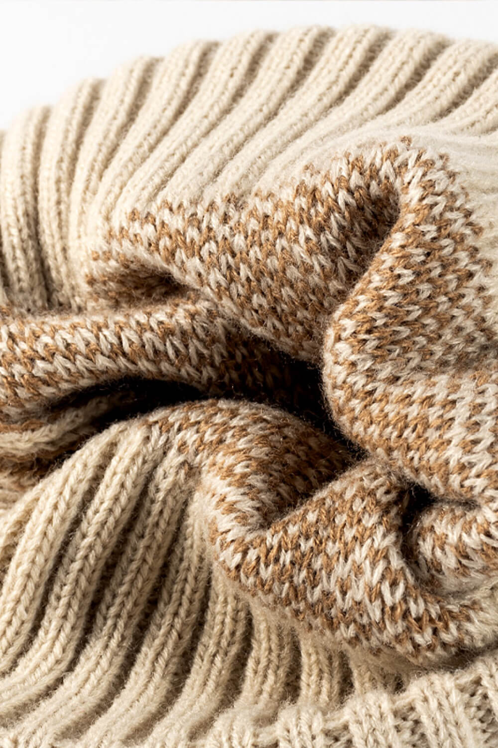 Beige acrylic beanie with textured leopard print and ribbed knit detail.