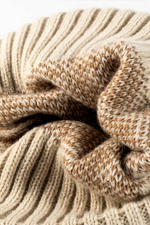 Beige acrylic beanie with textured leopard print and ribbed knit detail.
