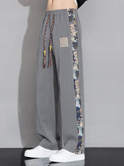 Men's light gray sweatpants with printed side stripe and drawstring waist.