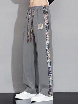 Men's light gray sweatpants with printed side stripe and drawstring waist.
