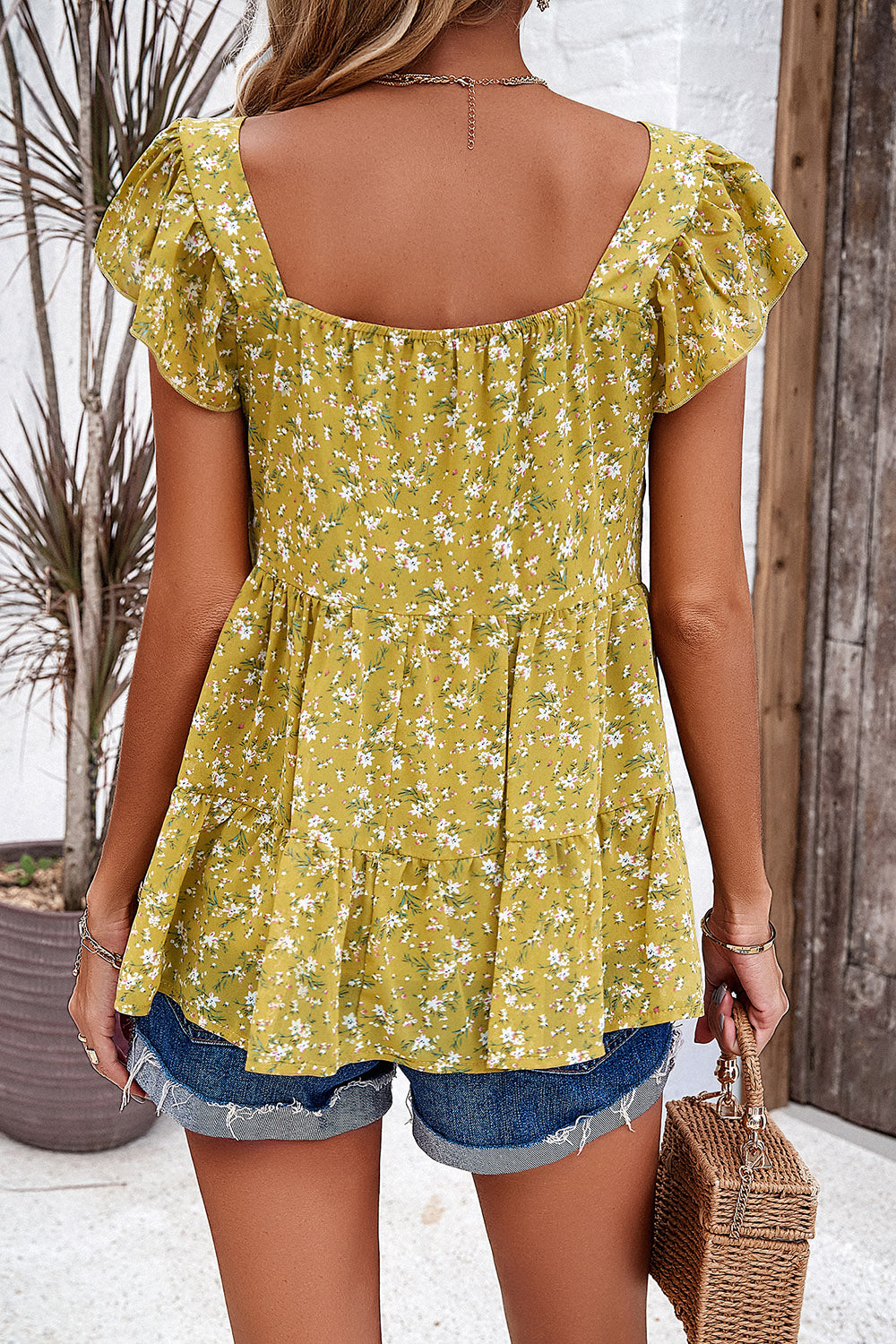 Chartreuse floral peplum blouse with flutter sleeves and tiered hem.