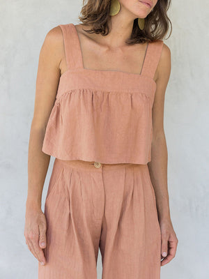 Watermelon pink linen crop top with square neckline and culotte pants with button detail.