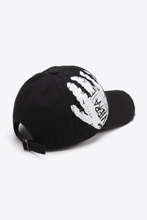 Black baseball cap with white graffiti hand print and VIBRA text, adjustable strap.