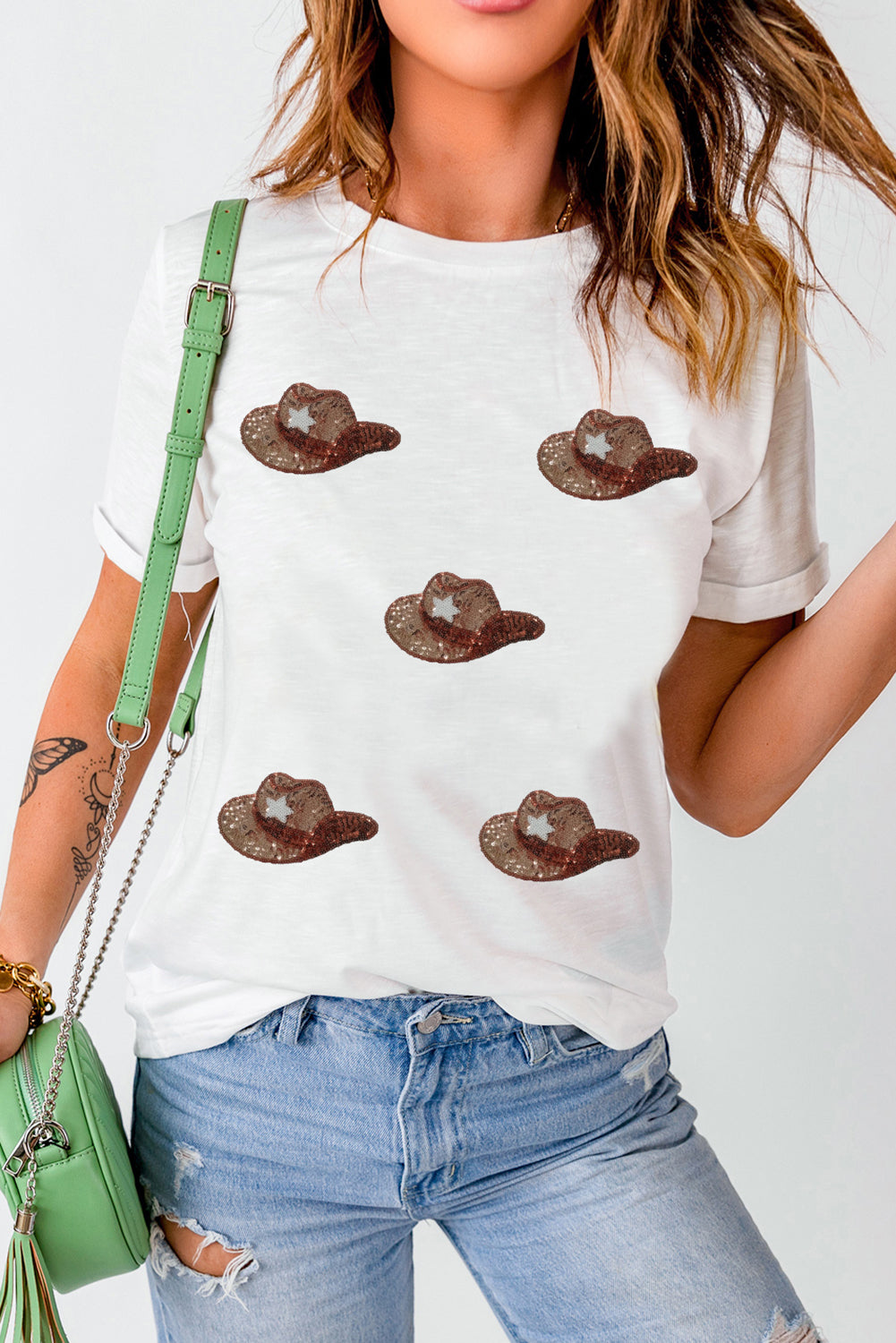 White cotton blend t-shirt with allover sequin cowboy hat graphic.