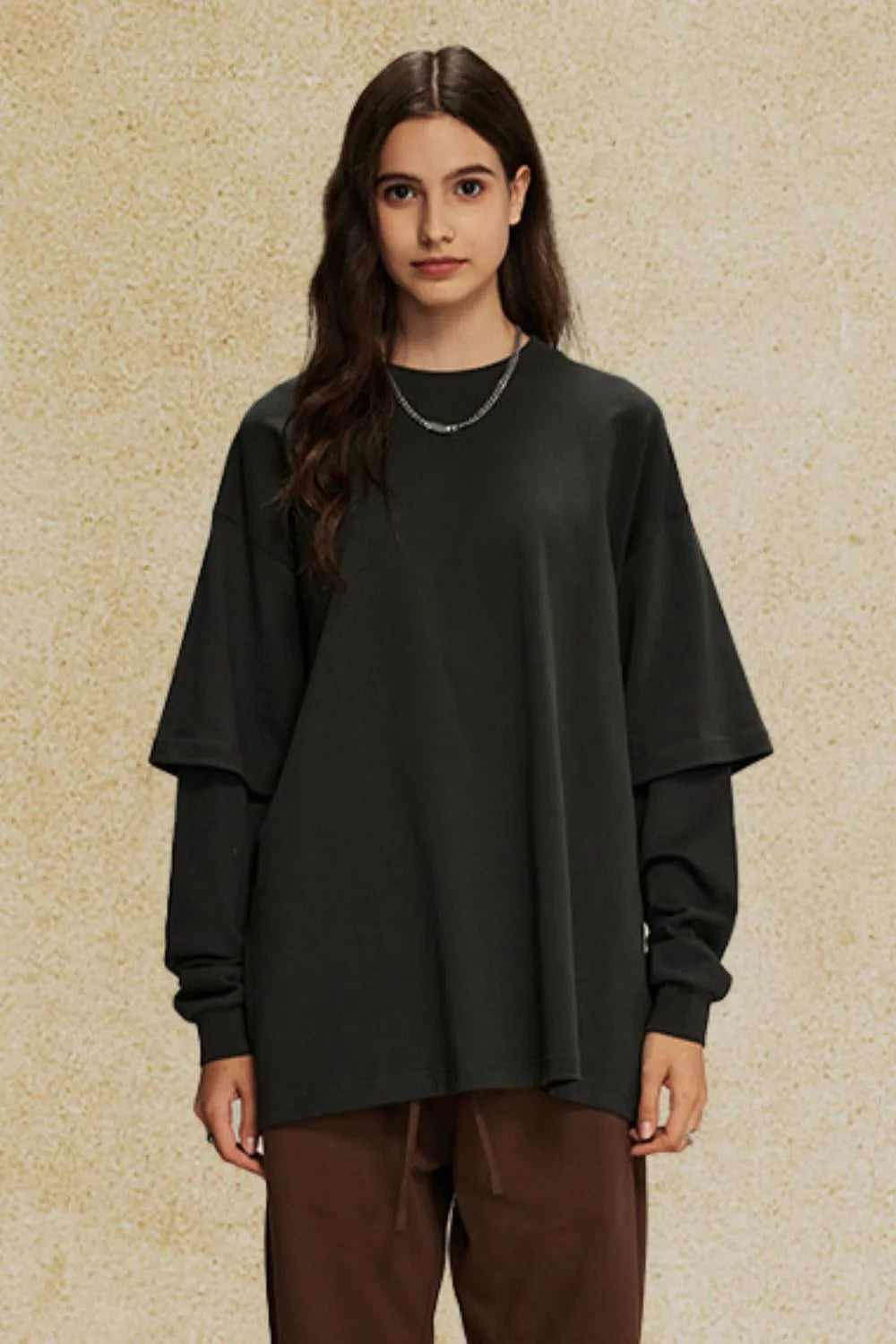 Oversized black t-shirt with layered long sleeves and crew neck.