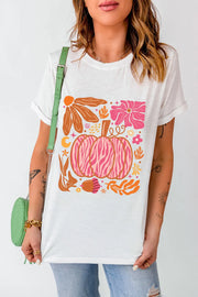 White crewneck tee with a pink and orange graphic of a pumpkin surrounded by autumn floral elements.