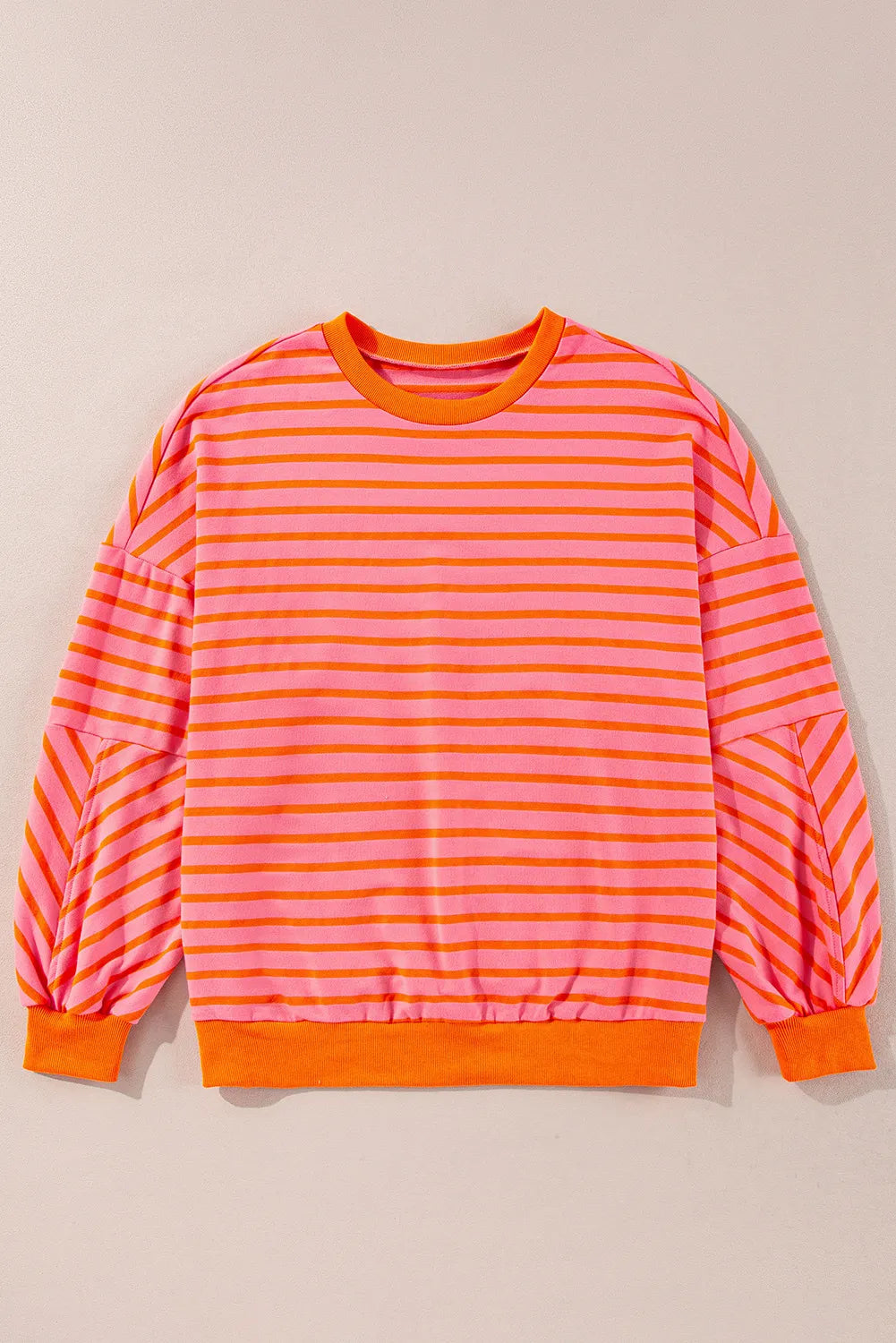 Chevron-Inset Stripe Sweatshirt in pink with orange stripes, crew neck, and balloon sleeves.