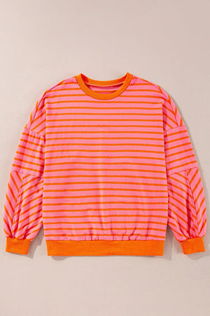 Chevron-Inset Stripe Sweatshirt in pink with orange stripes, crew neck, and balloon sleeves.
