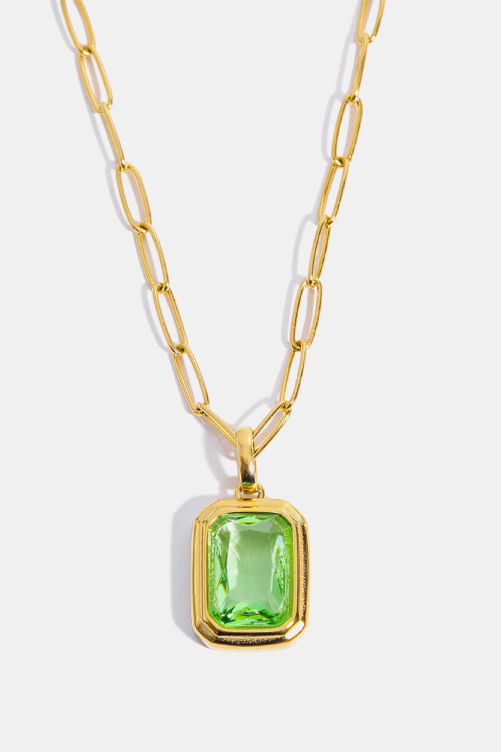 Gilded Prism Pendant Necklace with light green emerald-cut stone and 18K gold chain.
