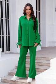 Green textured tie-sleeve co-ord set with flare pants and collared button-up shirt.