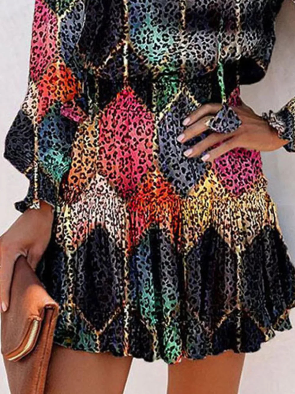 Abstract leopard print tiered mini dress with ruffles and gold chain detail.
