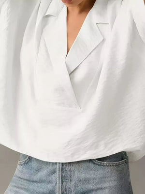 White V-neck half sleeve shirt with a textured fabric and relaxed fit, styled with denim.