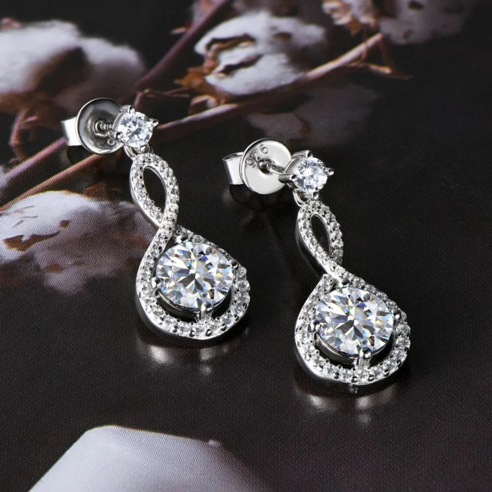 Infinity drop aquamarine earrings with white stones and silver setting.