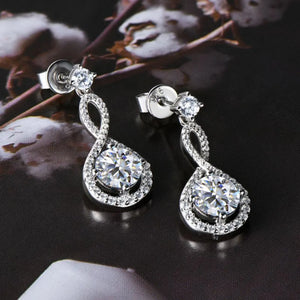Infinity drop aquamarine earrings with white stones and silver setting.