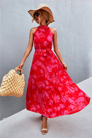 Red floral print halter maxi dress with tiered skirt and tie waist.