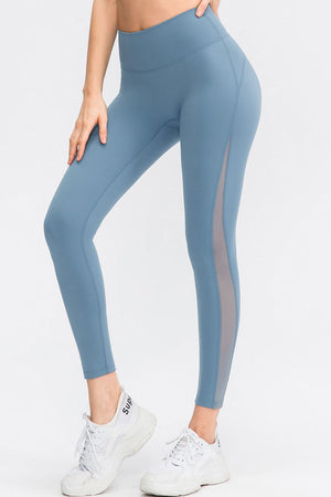 Light blue performance leggings with mesh side panels and a high waist.