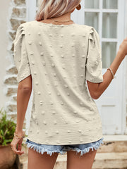 Beige textured dotty puff sleeve blouse with a casual fit.