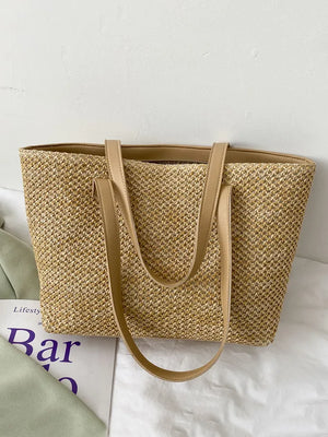 Textured straw shopper bag in beige with tan leather straps.