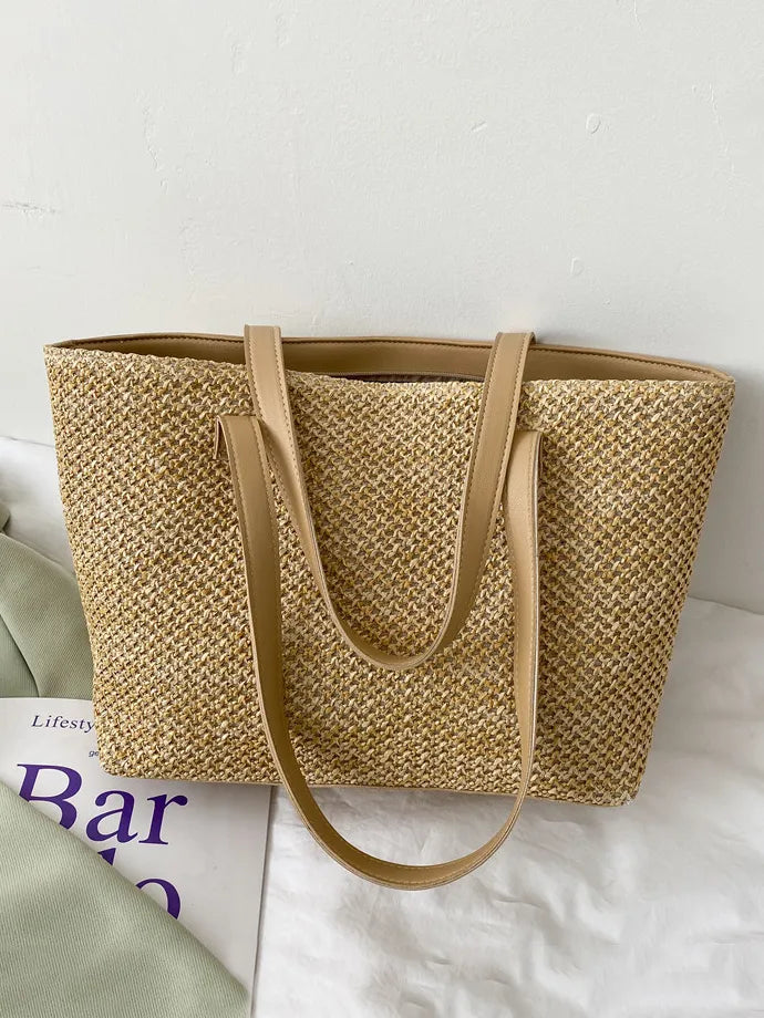 Textured straw shopper bag in beige with tan leather straps.