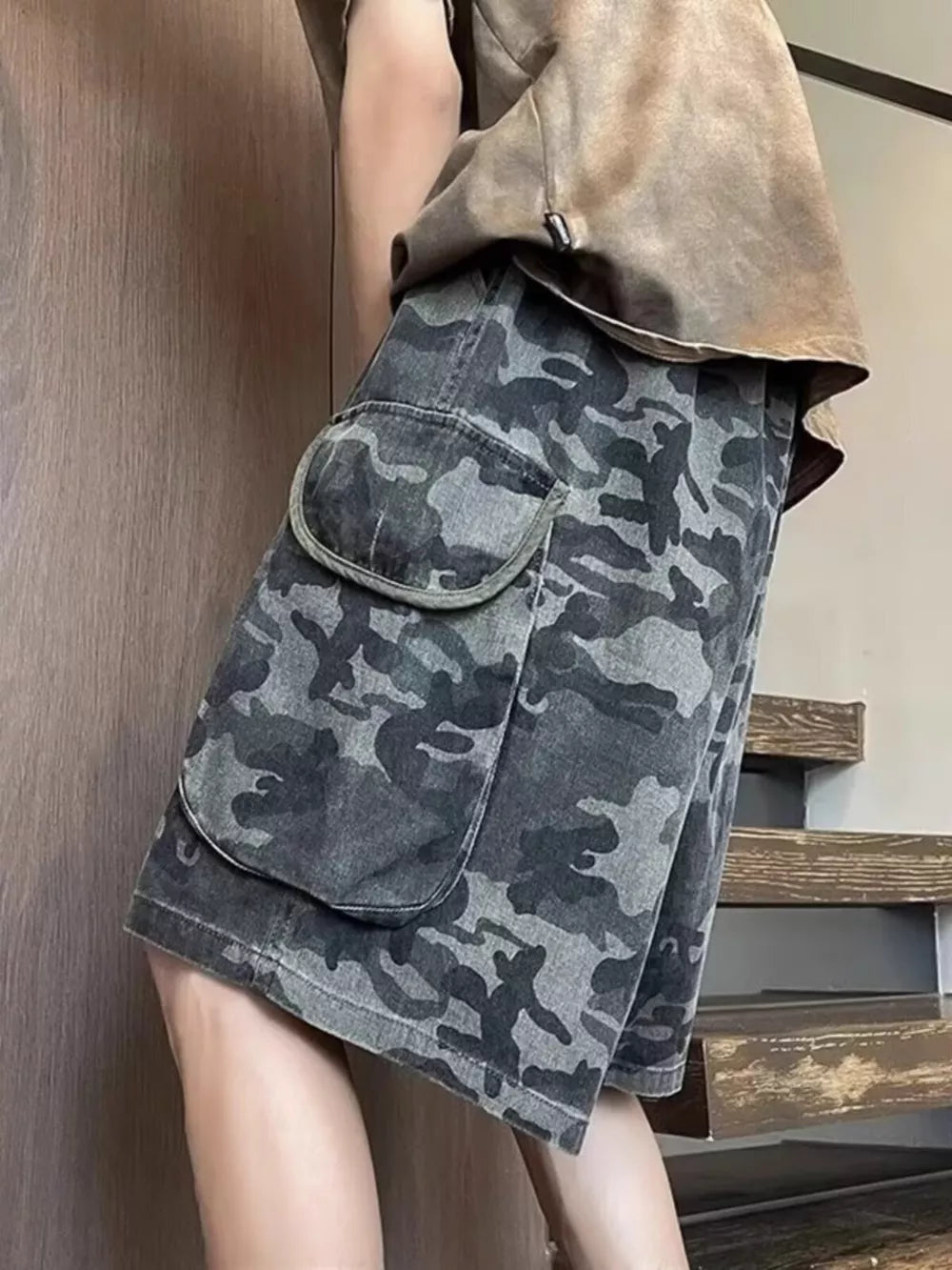 Relaxed fit black camo cargo shorts with large flap pockets.