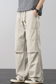 Beige cargo pants with adjustable drawstring and multiple pockets.