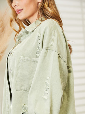 Light green distressed denim overshirt with raw hem detail and button front.