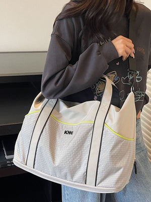 Large gray nylon duffel bag with grid pattern and neon yellow trim.