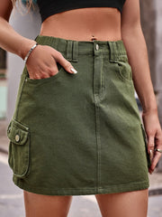Army green denim mini skirt with cargo pockets and a button fly.
