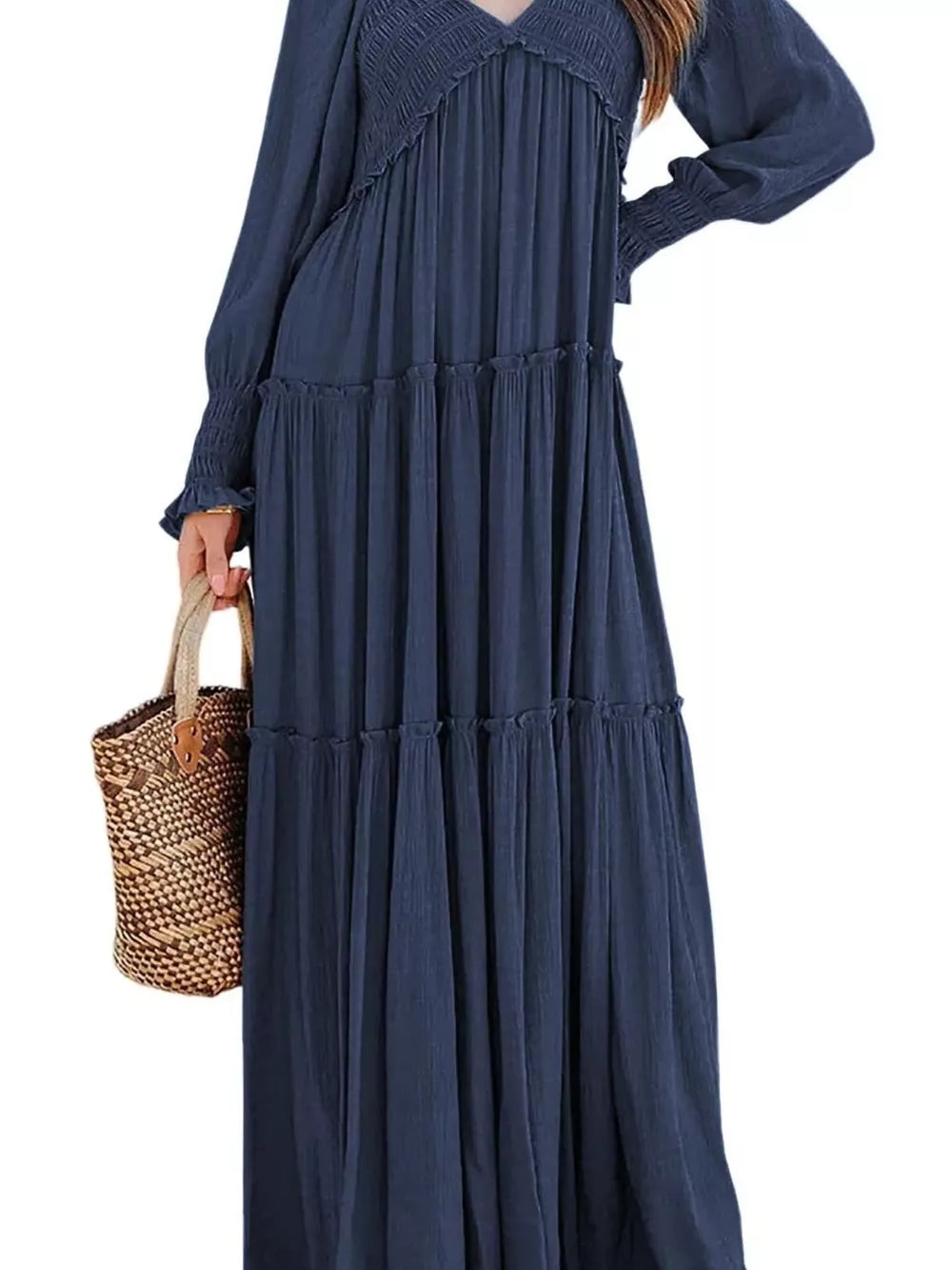 Blue smocked V-neck tiered maxi dress with long sleeves and ruffled cuffs.