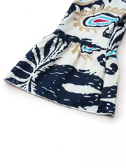 Vibrant tiered mini dress with abstract print, button detail, and collared neckline.